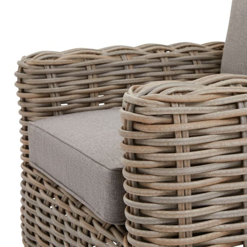 Close up of Rattan chair with beige cushions, fabric, metal, synthetic fibres